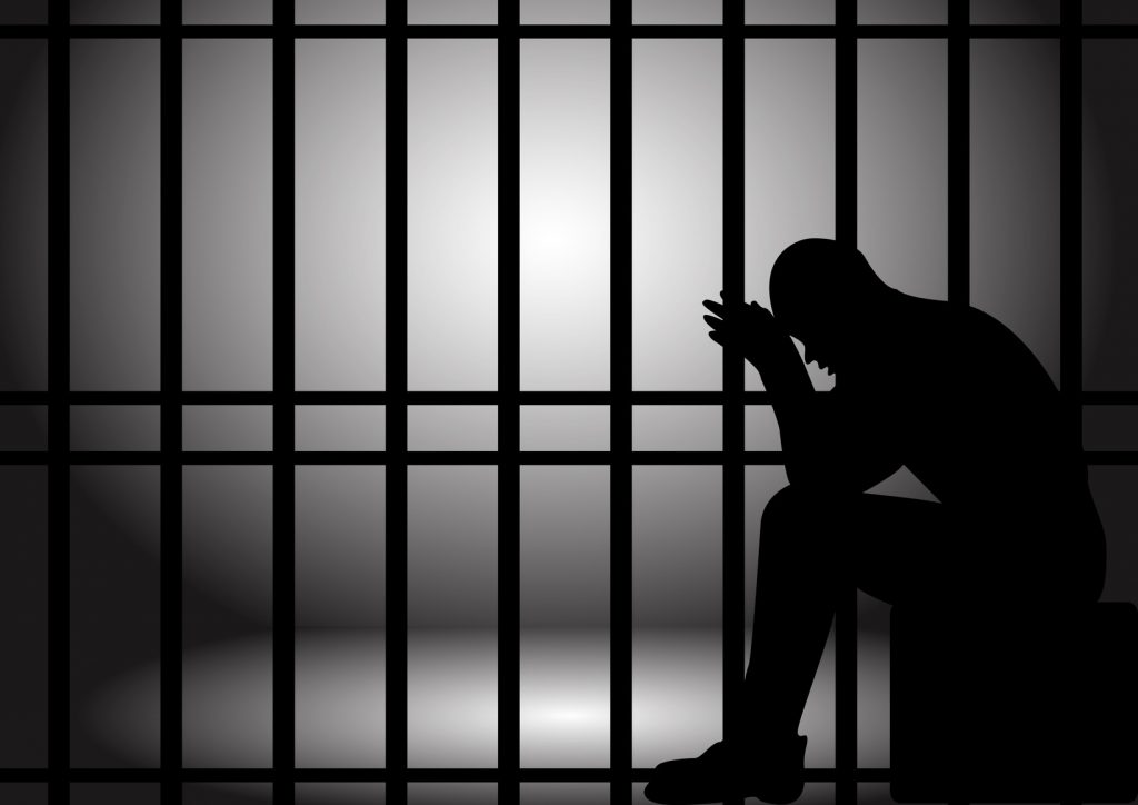 Husband jailed for punching a man in his bedroom