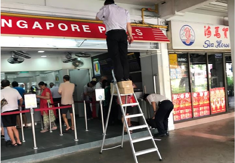 CONTRACTORS AT ANG MO KIO. CLIMB LADDER THEN STACK WITH BOX.