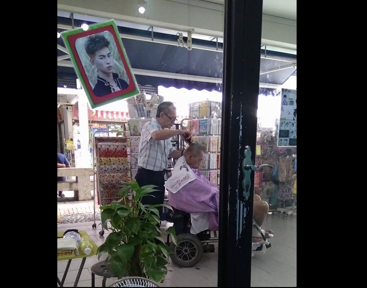 BARBER GOES THE EXTRA MILE TO GIVE WHEEL-CHAIRED BOUND CUSTOMER A HAIRCUT OUTSIDE HIS SALON!
