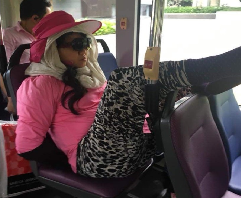 PRC WOMAN HANGING HER CHAO CHEE B…. IN BUS
