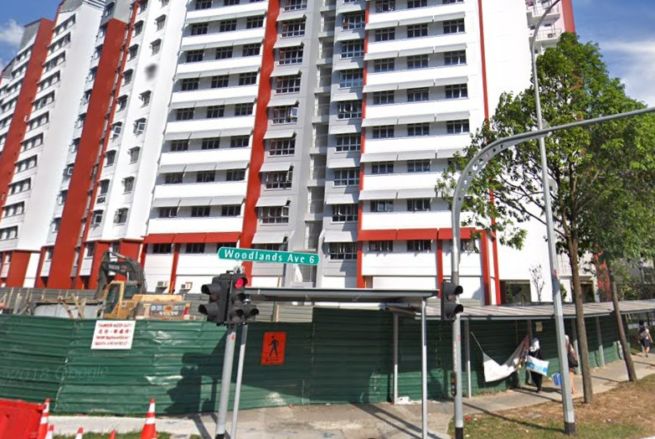 WOMAN FOUND DEAD AT WOODLANDS. LYING MOTIONLESS IN A ROOM