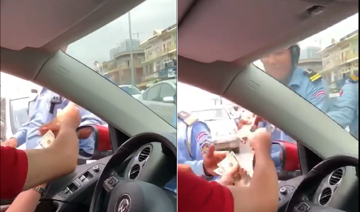 CAMBODIAN POLICE TAKE BRIBE TO HELP CAR GET OUT OF TRAFFIC JAM