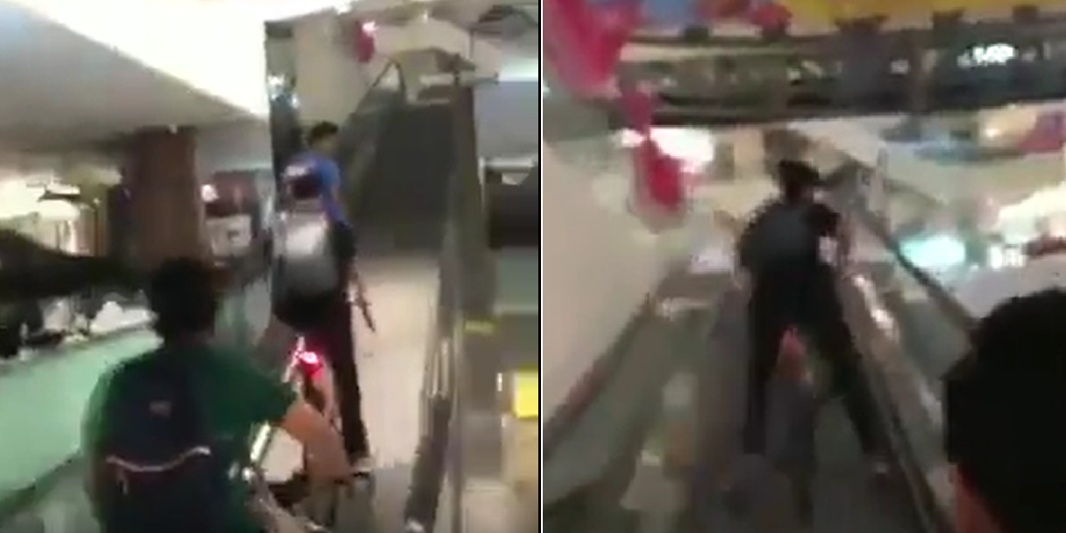 YOUNGSTERS RIDING BICYCLE ON ESCALATORS IN SHOPPING MALL