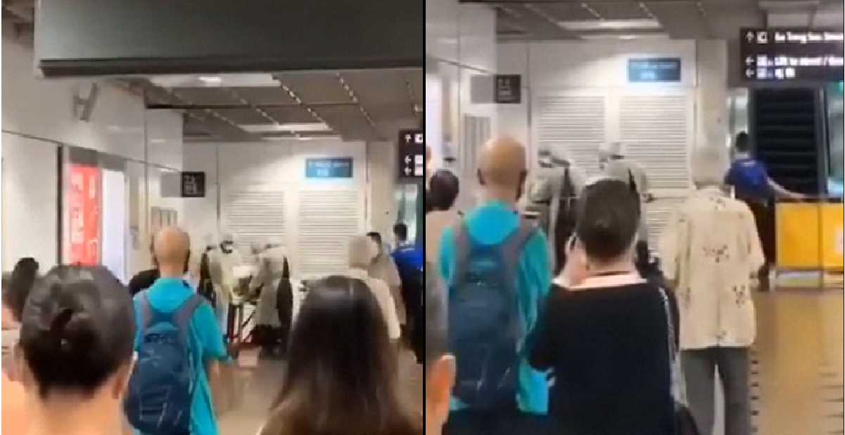 MEDICAL PERSONNEL SEEN LOADING PERSON ON STRETCHER AT CHINATOWN MRT