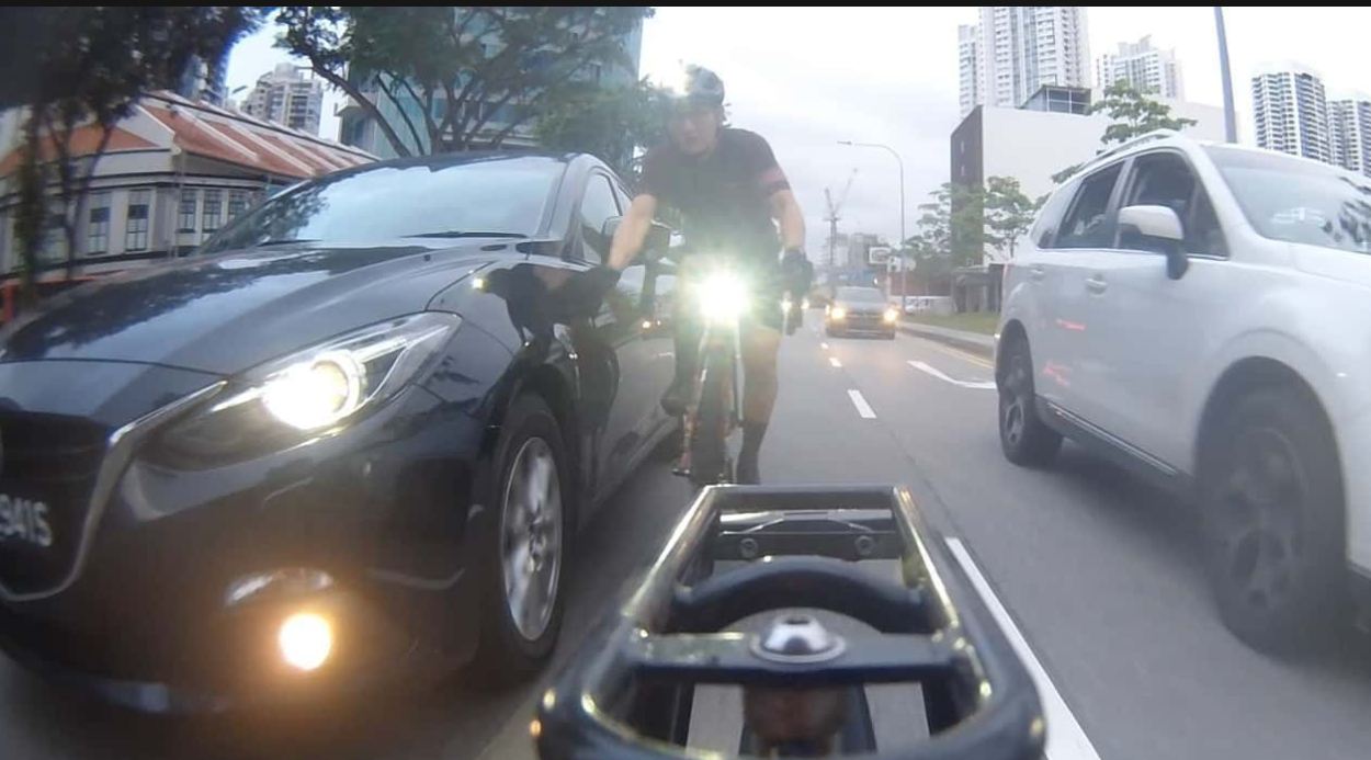 CYCLIST CLAIMS THAT HE WAS SIDESWIPED BY CAR IN MIDDLE OF ROAD