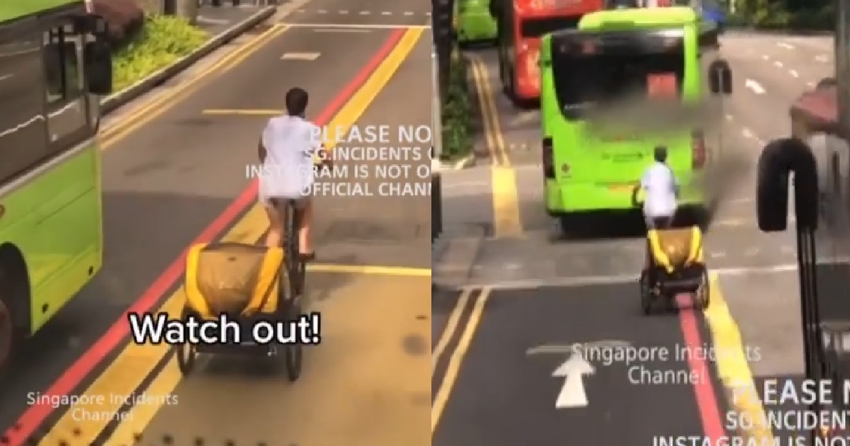 CYCLIST SWERVING IN AND OUT OF BUS LANE WITH HER BABY AT THE BACK
