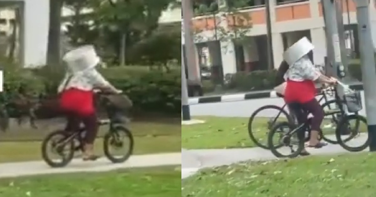 AUNTIE SEEN USING HUGE METAL POT AS A BICYCLE HELMET