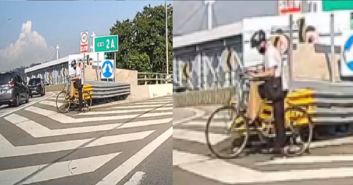 ERRANT CYCLIST JUST CHILLING WITH HIS BICYCLE IN THE MIDDLE OF EXPRESSWAY