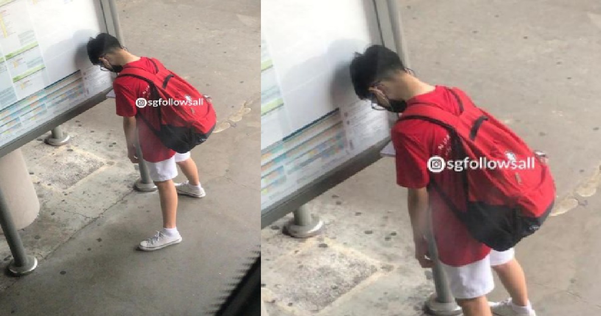 YOUNG BOY LEANS HEAD AGAINST INFORMATION BOARD BECAUSE HE HAS HAD ENOUGH