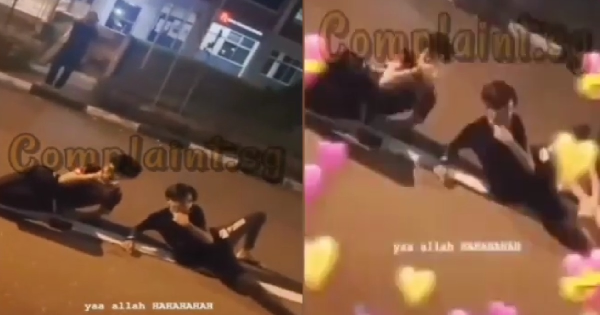 YOUNG PUNKS LIE DOWN IN MIDDLE OF ROAD, POSE LIKE MERMAID FOR CAMERA