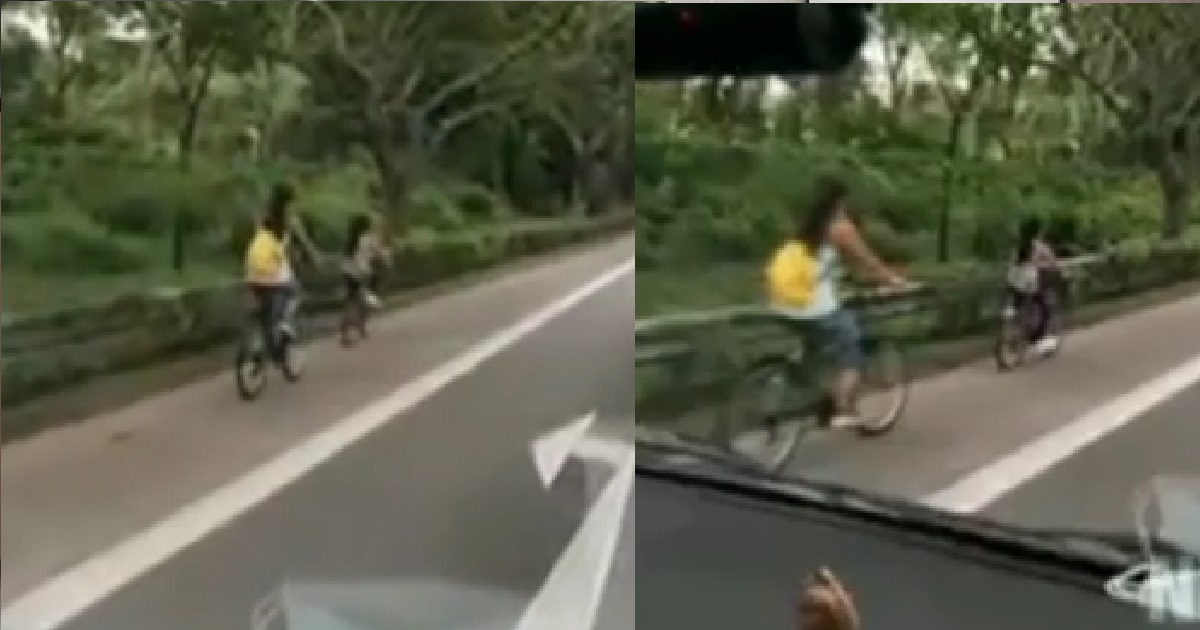 MOTHER BRING HER YOUNG DAUGHTER CYCLING ON EXPRESSWAY