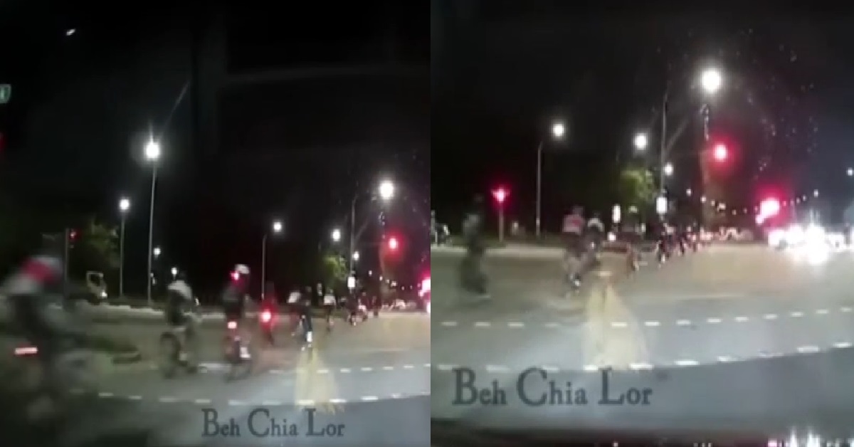 MASSIVE GROUP OF CYCLISTS ON ROAD, CASUALLY RUNNING RED LIGHT