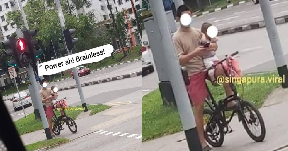 CYCLIST CYCLING DANGEROUSLY WITHOUT HELMET – ONE HAND HOLD BABY, ONE HAND CYCLE