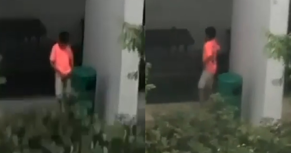 YOUNG PUNK PEEING INSIDE DUSTBIN BECAUSE THE WORLD IS HIS TOILET