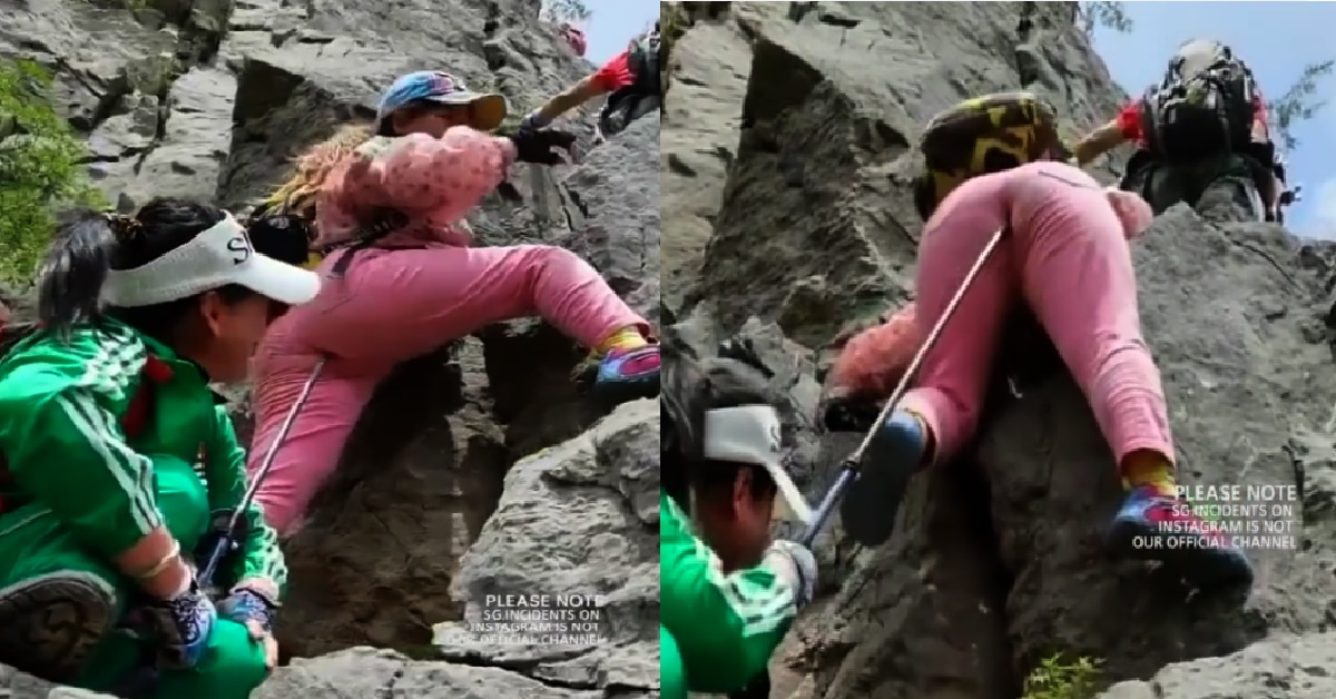 WOMAN ENCOURAGES FRIEND CLIMBING MOUNTAIN, BY POKING STICK UP HER BACKSIDE