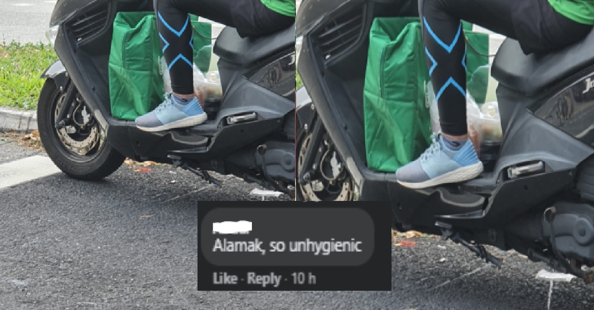 GRABFOOD RIDER SEEN PUTTING FOOD ON FOOTREST OF MOTORCYCLE