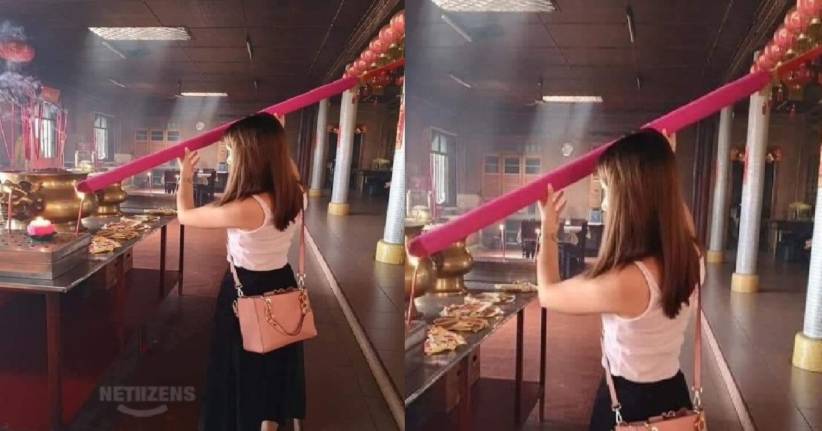 KIASU WOMAN PRAYING WITH JOSS STICK THAT IS TALLER THAN HER