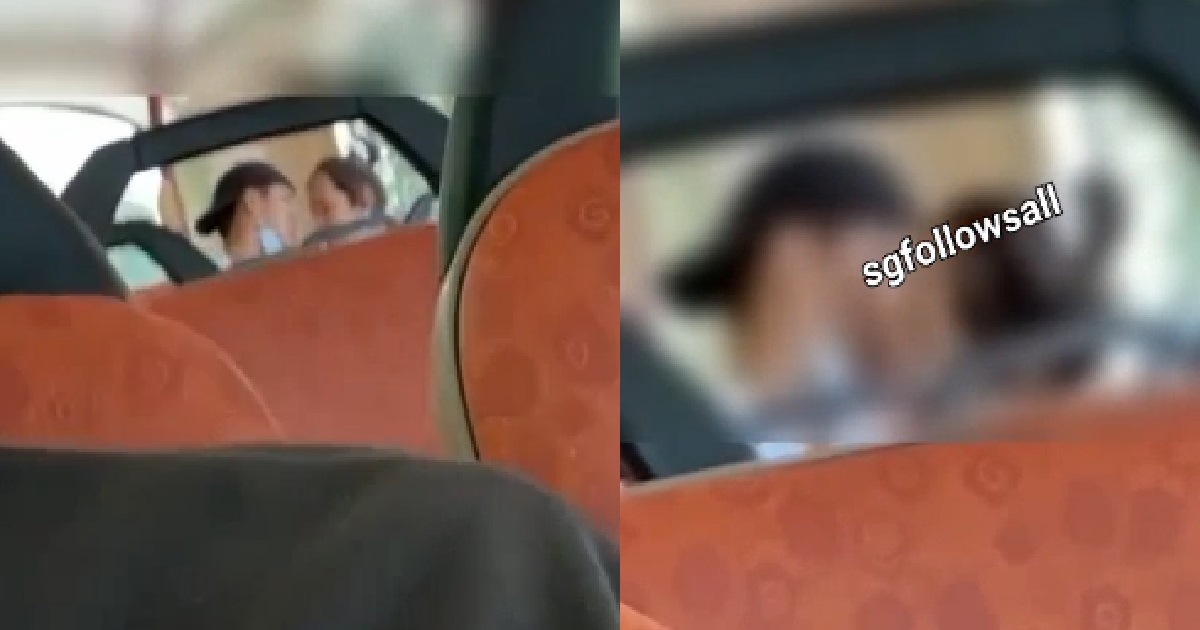 COUPLE KISSING AT THE BACK OF BUS, IN FRONT OF SCHOOL CHILDREN