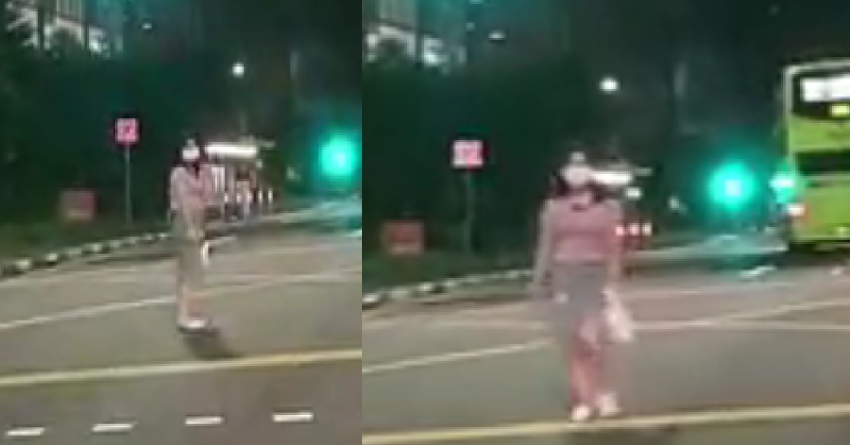 WOMAN WHO APPEARS TO BE DRUNK STANDS IN THE MIDDLE OF THE ROAD