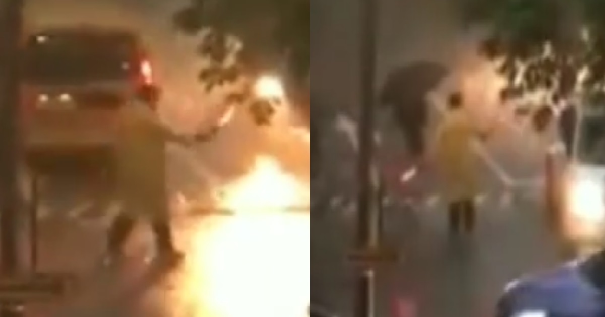 KIND UNCLE STANDING IN HEAVY RAIN TO DIRECT TRAFFIC FOR KIDS TO CROSS SAFELY