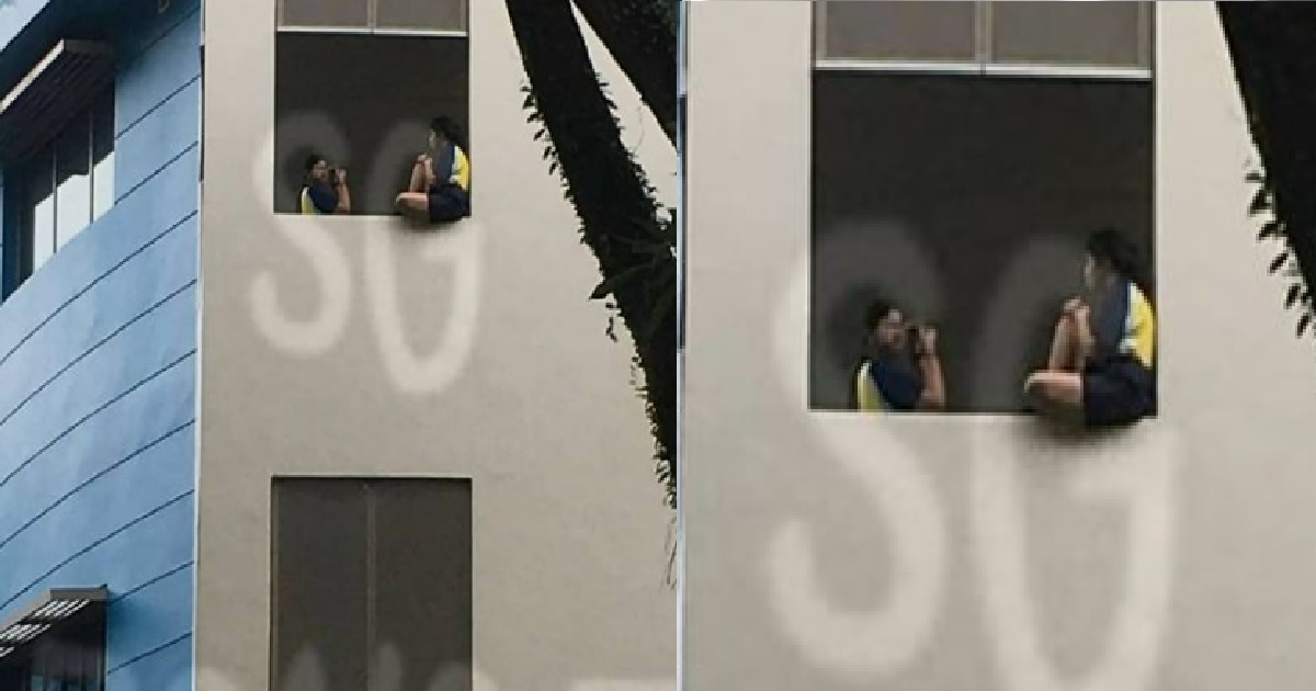 YP SITTING ON WINDOW LEDGE OF SCHOOL TO SEE IF GRAVITY STILL WORKS