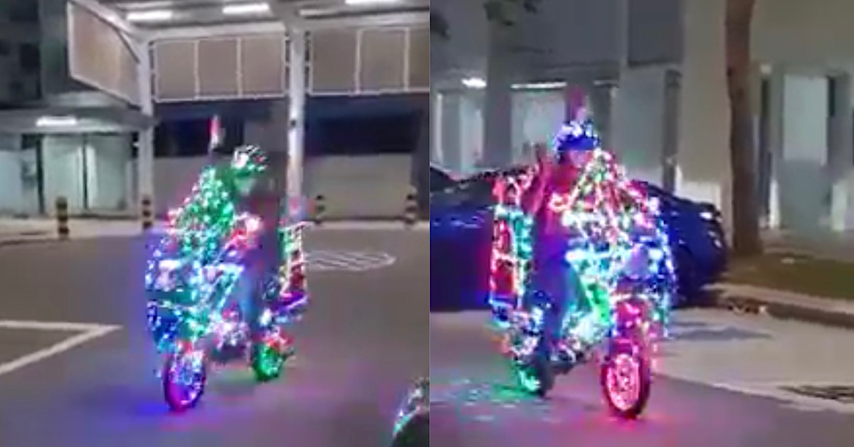 PATRIOTIC UNCLE RIDES XMAS TREE BIKE AROUND AND BLASTS NDP SONGS