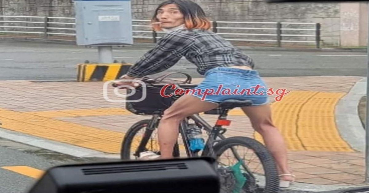 “GIRL” OR “GUY” CYCLING WITH HIGH WAIST SHORTS TURNS BACK TO LOOK