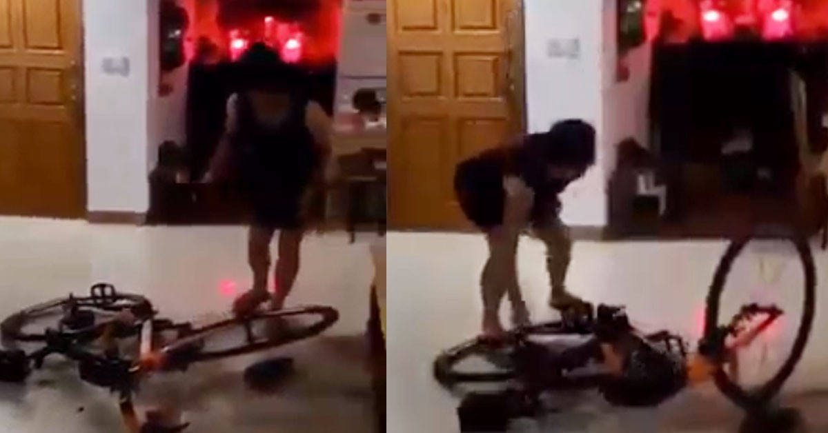 WOMAN PERFORMS EXORCISM BY BY SMASHING BICYCLE WITH A HAMMER