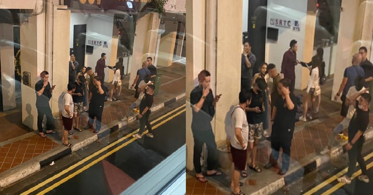 SMOKERS GATHER IN LARGE GROUP OUTSIDE SHOP TO SHARE VIRUS & CANCER