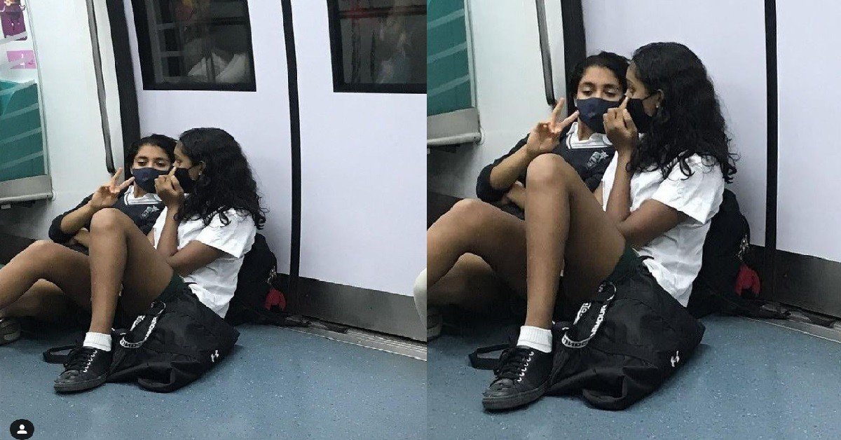 STUDENTS SITTING ON FLOOR AGAINST TRAIN DOOR, BLOCKING THE EXIT