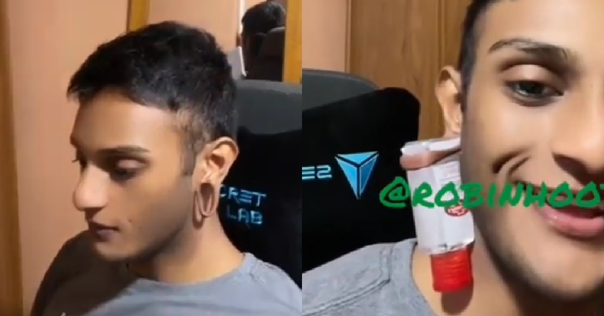 GUY WITH EXTENDED EARLOBES USE IT TO HOLD HIS BOTTLE OF HAND SANITISER