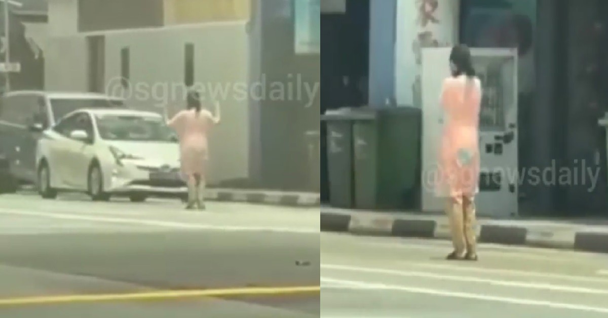 WOMAN STAND IN MIDDLE OF ROAD TO DIRECT TRAFFIC FOR NO REASON