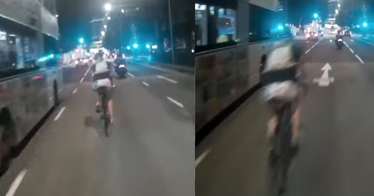 CYCLIST RIDES BICYCLE IN THE MIDDLE OF ROAD