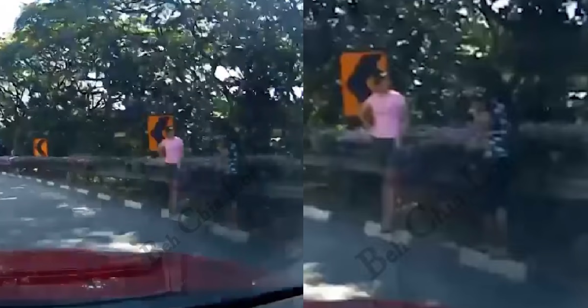 WOMEN STANDING ON EXPRESSWAY TO POSE AND TAKE PHOTOS OF EACH OTHER