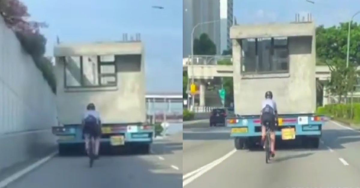 ERRANT CYCLIST RIDING RIGHT BEHIND LORRY, IN THE MIDDLE OF THE ROAD