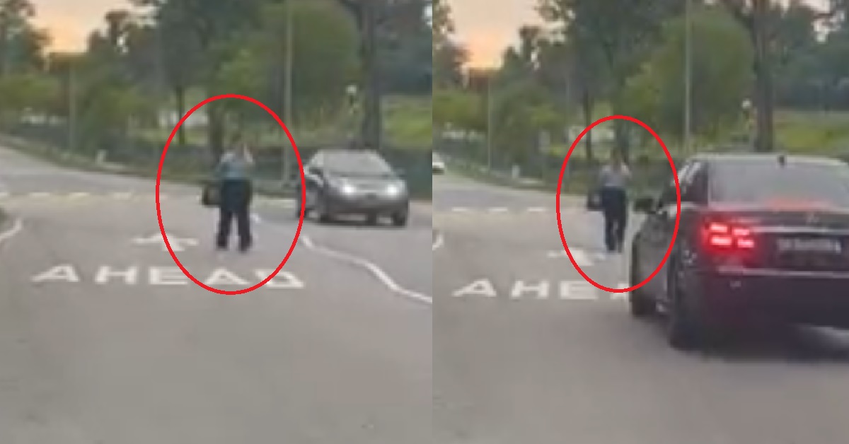 WOMAN USING PHONE IN MIDDLE OF THE ROAD LIKE HER AH GONG BUILT IT