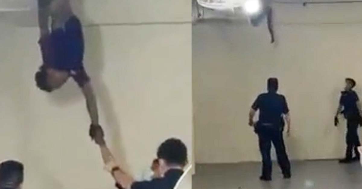 POLICE TRYING TO CATCH A MAN HANGING FROM CEILING OF HDB VOID DECK