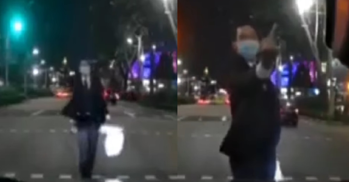 JAYWALKER CONFRONTS CAR IN MIDDLE OF ROAD, POINTS MIDDLE FINGER