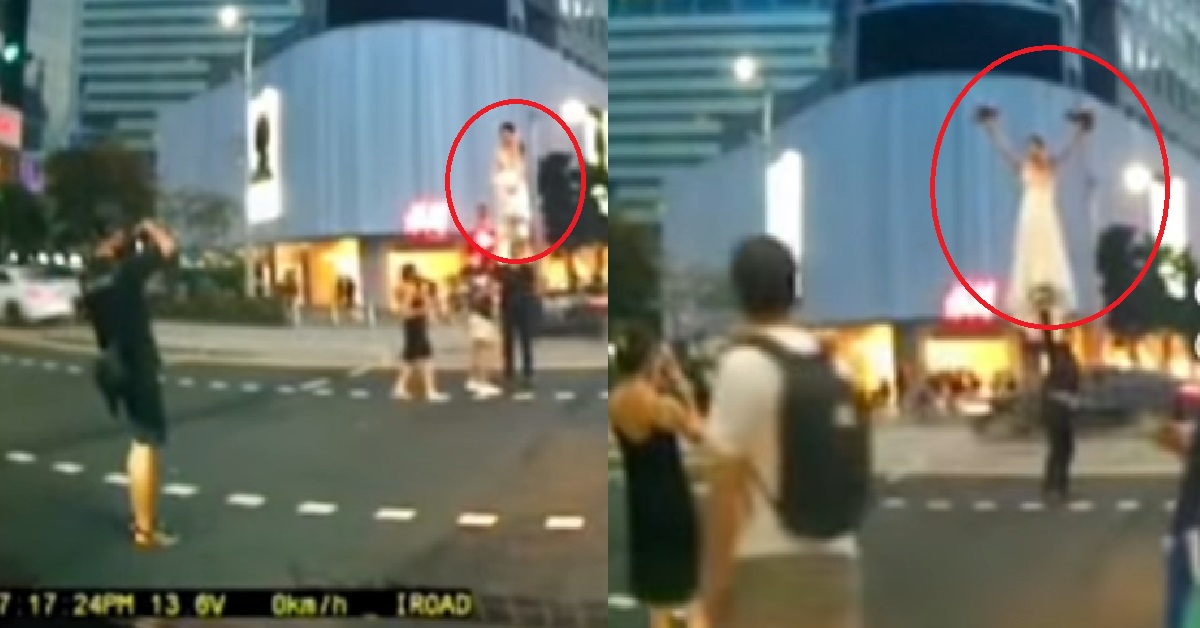 GROOM LIFTS BRIDE WITH ONE HAND IN MIDDLE OF ORCHARD RD FOR PHOTOSHOOT