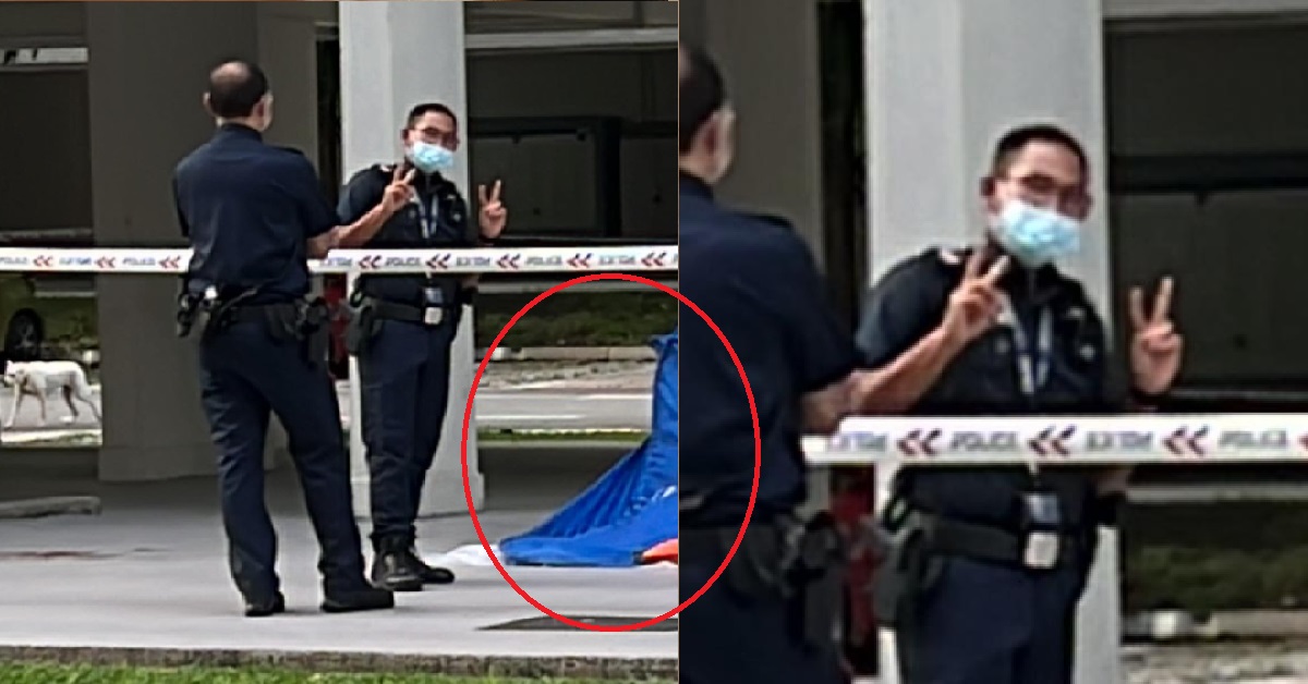 POLICEMAN POSING FOR PHOTOS BESIDE DEAD BODY UNDER BLOCK