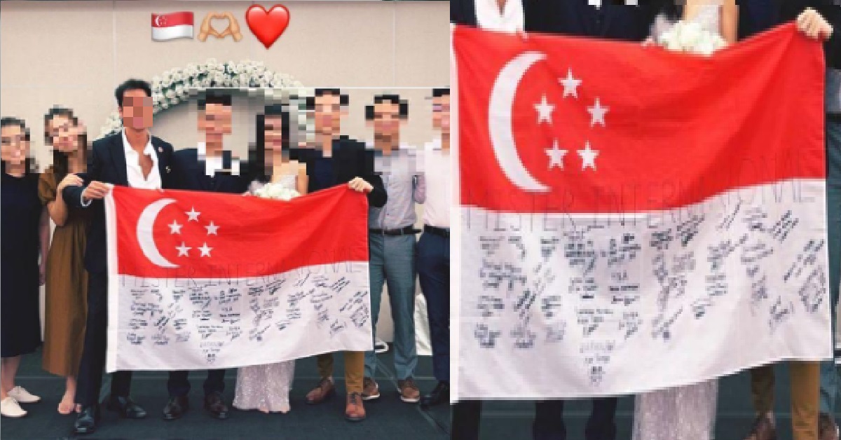 S’PORE FLAG ALLEGEDLY “DEFACED” IN GROUP PHOTO, HAD 40 SIGNATURES ON IT