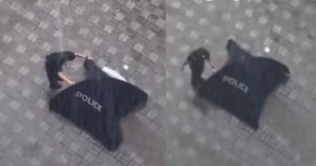 RESPECTFUL POLICEMAN ADJUSTS BLUE TENT & WATCHES OVER DEAD BODY IN THE RAIN