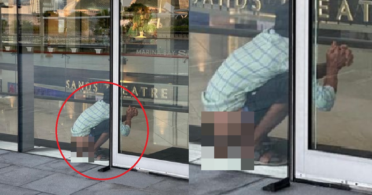 MAN PANGSAI AT MBS ENTRANCE, PALMS TOGETHER LIKE HE ASKING GOD FOR HELP